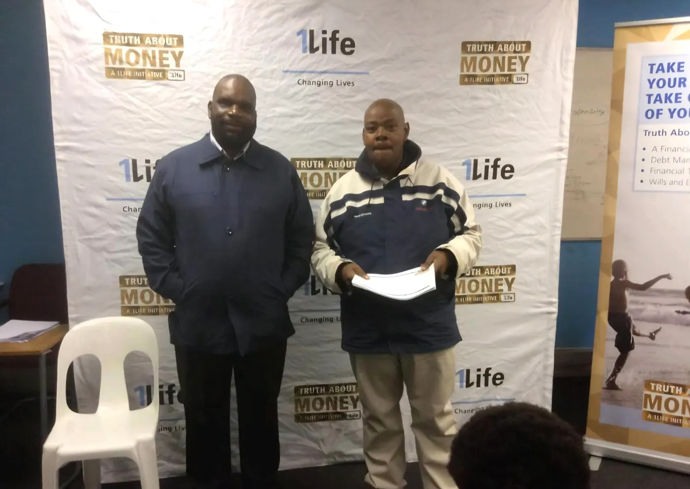 Sicelo with a participant at a Truth About Money financial literacy session